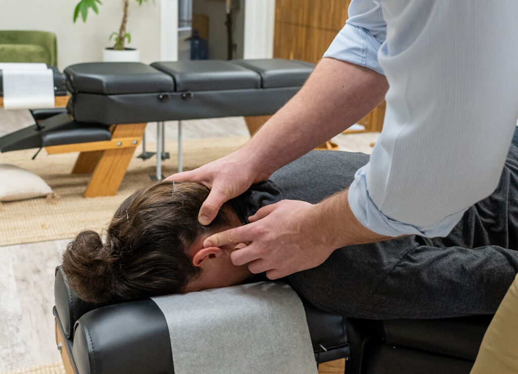 A chiropractor at Vita Nova Chiropractic in Plano, TX providing gentle chiropractic care to help relieve nasal congestion and support natural healing.