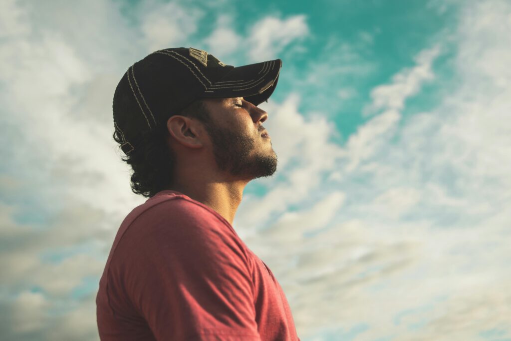 man experiencing migraine pain, holding head in discomfort