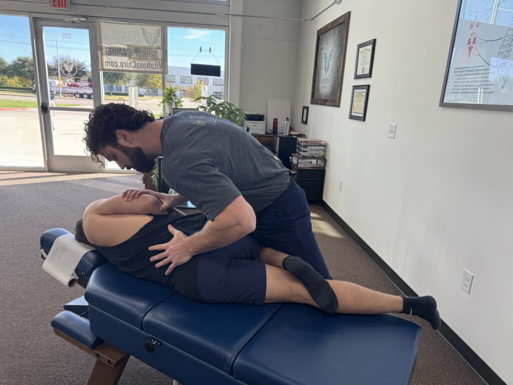 A chiropractor at Vita Nova Chiropractic in Plano, TX providing gentle chiropractic care to help relieve pinched nerve and support natural healing.