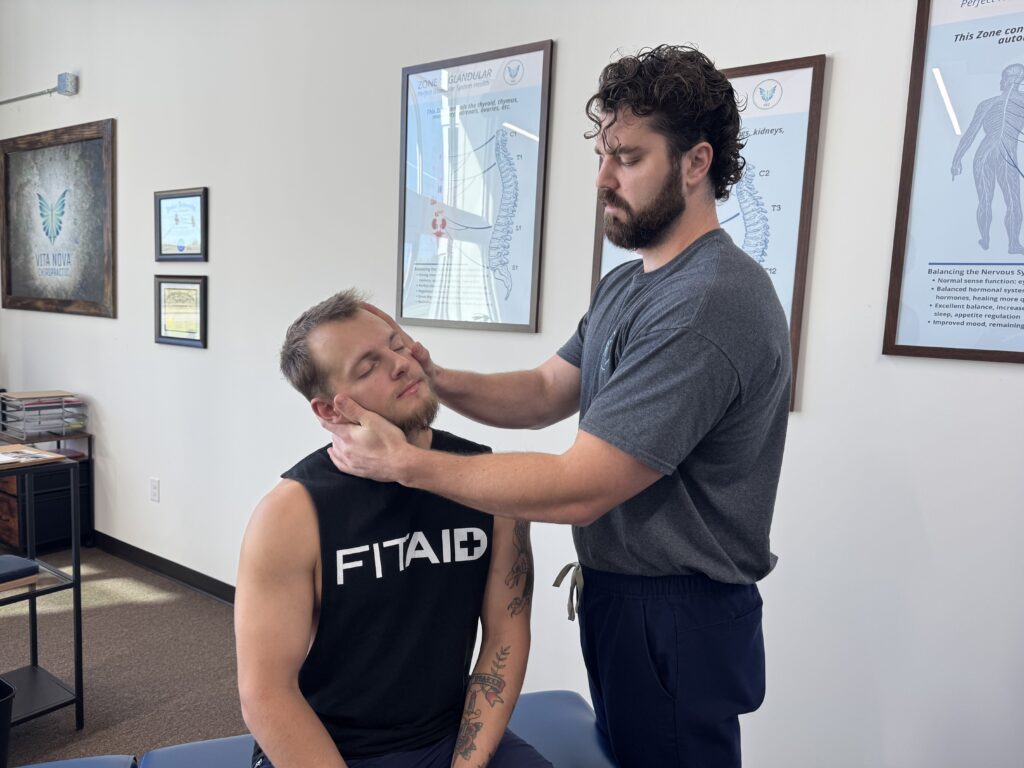 Chiropractor at Vita Nova Chiropractic in Plano, TX performing gentle neck adjustment to support eustachian tube function and help relieve recurring ear infections naturally