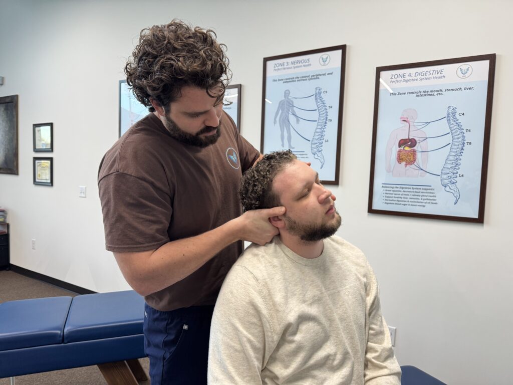 Chiropractor performing a cervical adjustment to help relieve symptoms of a pinched nerve in the neck