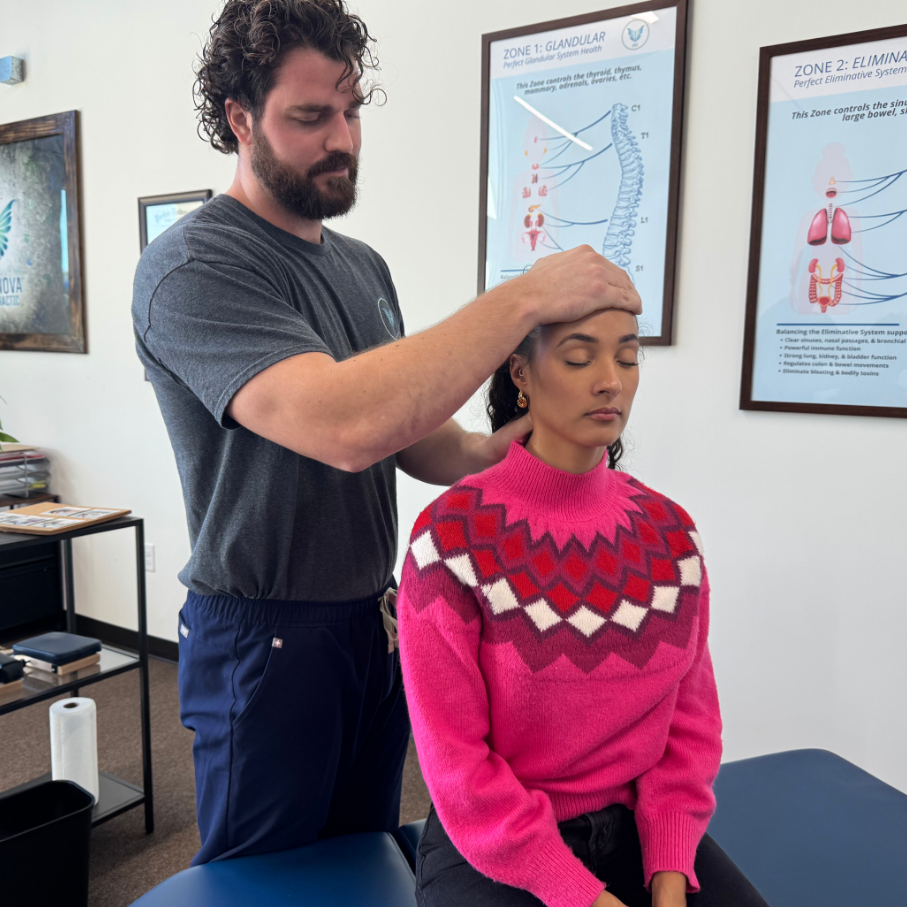 Dr. Korrin performing a holistic gentle adjustment on a patient at Vita Nova in Plano TX